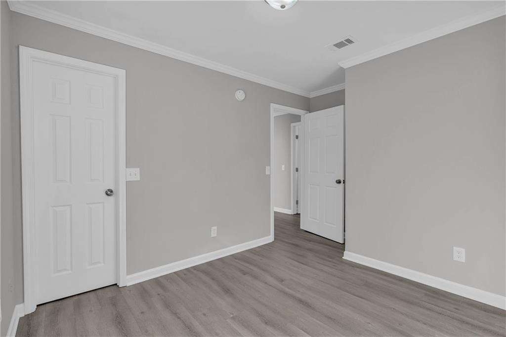 1040 Thomasville Estates Way Southeast Atlanta, GA 30315 - Photo 25 of 28 a view of an empty room with wooden floor