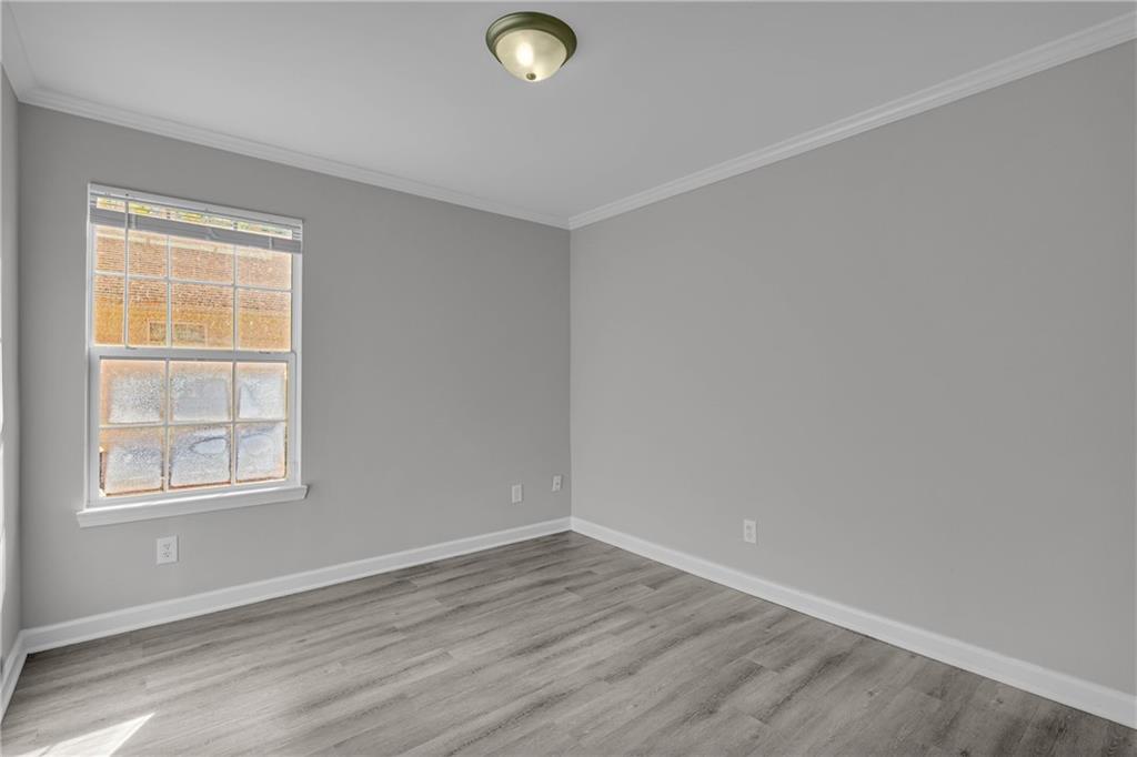 1040 Thomasville Estates Way Southeast Atlanta, GA 30315 - Photo 27 of 28 an empty room with wooden floor and windows