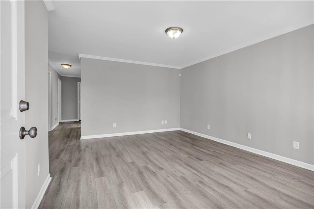 1040 Thomasville Estates Way Southeast Atlanta, GA 30315 - Photo 9 of 28 a view of an empty room with wooden floor