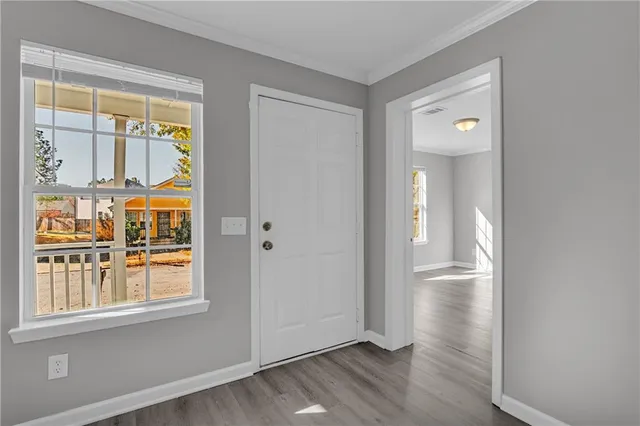 an empty room with wooden floor and closet