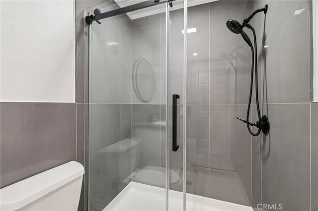 a bathroom with a toilet sink vanity and mirror