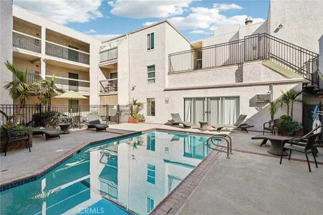 a view of a house with pool and sitting area