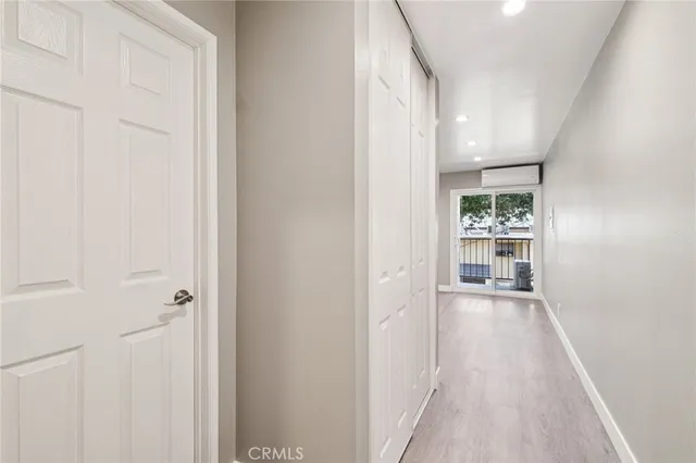 a kitchen with stainless steel appliances a stove a microwave and white cabinets