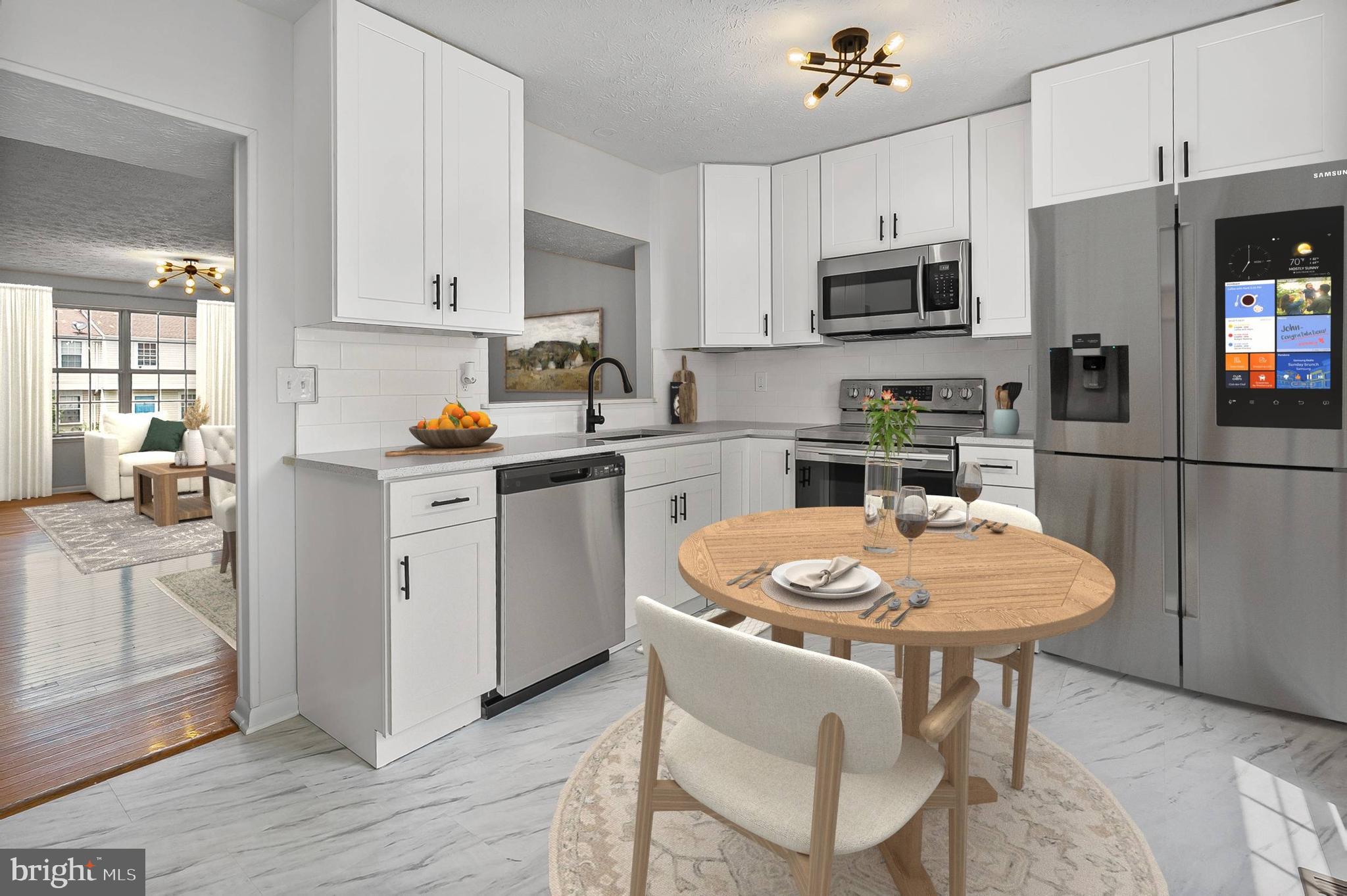 909 Olive Branch Court Edgewood, MD 21040 - Photo 11 of 36 a kitchen with stainless steel appliances kitchen island granite countertop a sink a stove a dining table and chairs