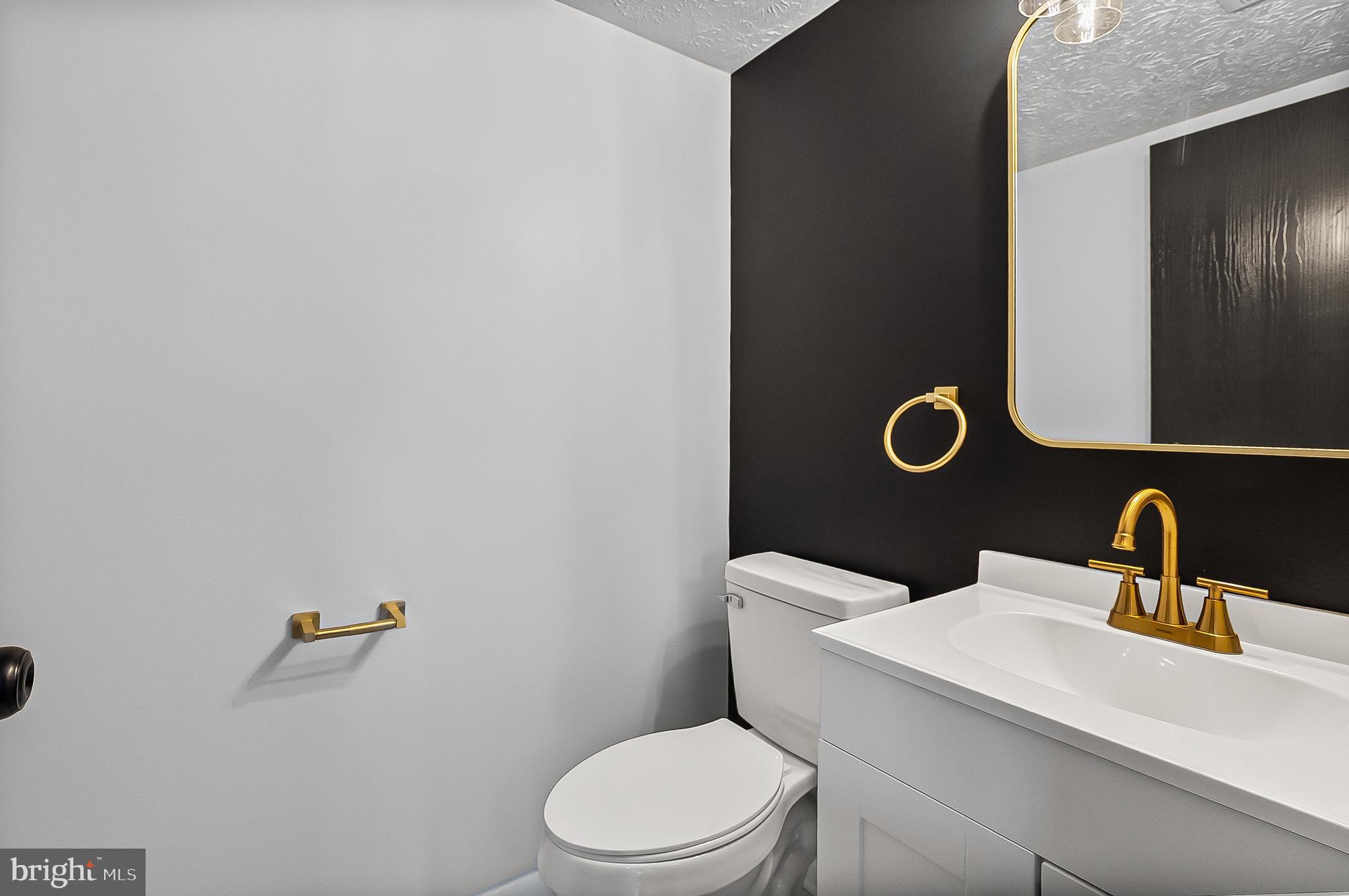 909 Olive Branch Court Edgewood, MD 21040 - Photo 15 of 36 a bathroom with a toilet sink and mirror