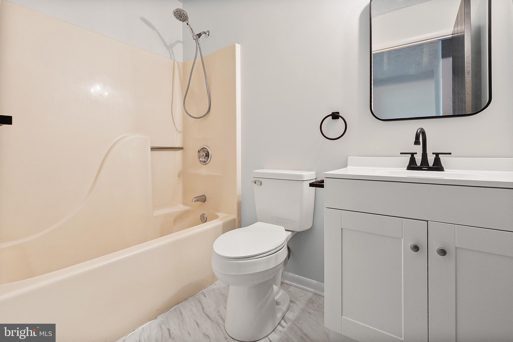 909 Olive Branch Court Edgewood, MD 21040 - Photo 27 of 36 a bathroom with a toilet sink vanity tub and mirror