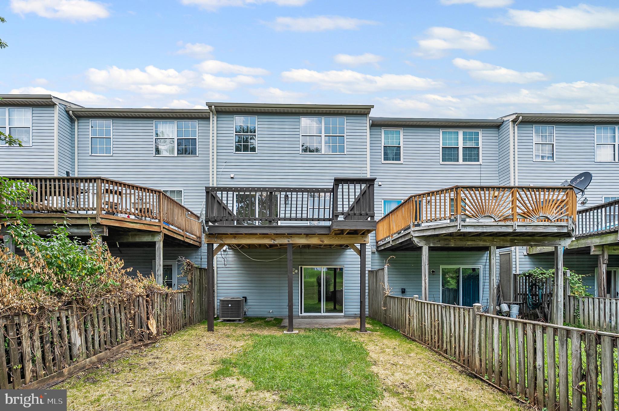 909 Olive Branch Court Edgewood, MD 21040 - Photo 35 of 36 a view of a white house with large windows and a small yard