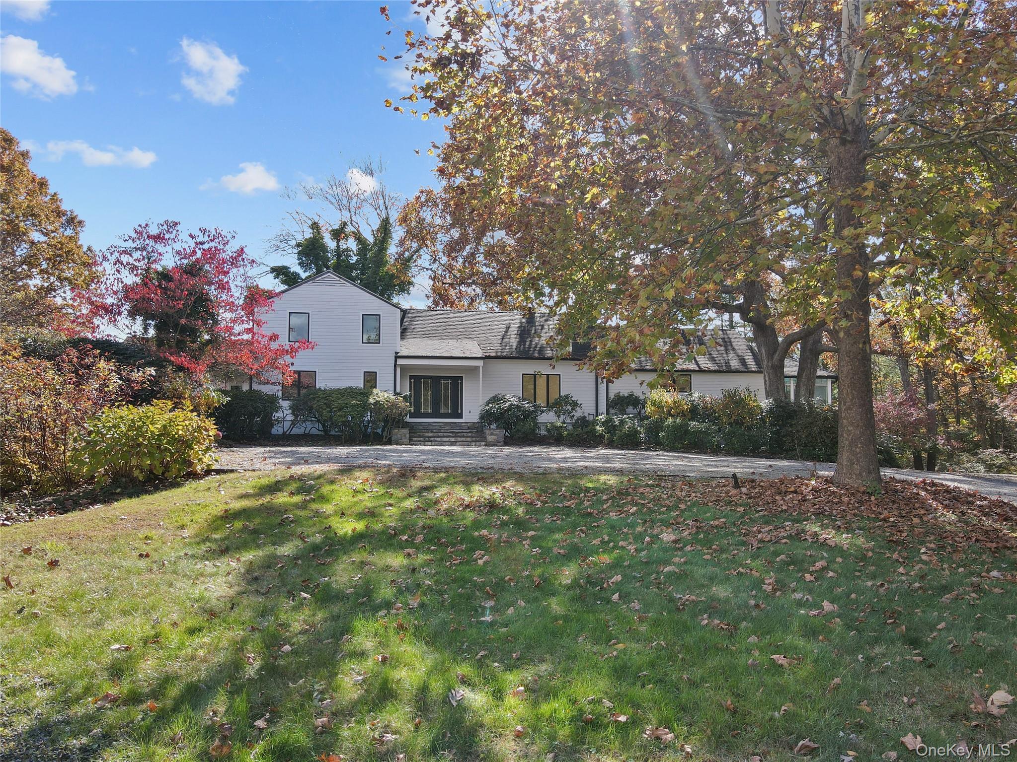 a front view of a house with a yard and fountain