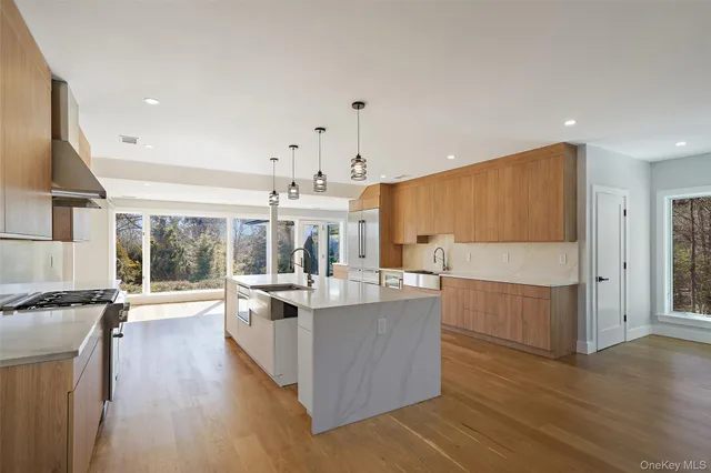 a kitchen with counter top space and wooden floor