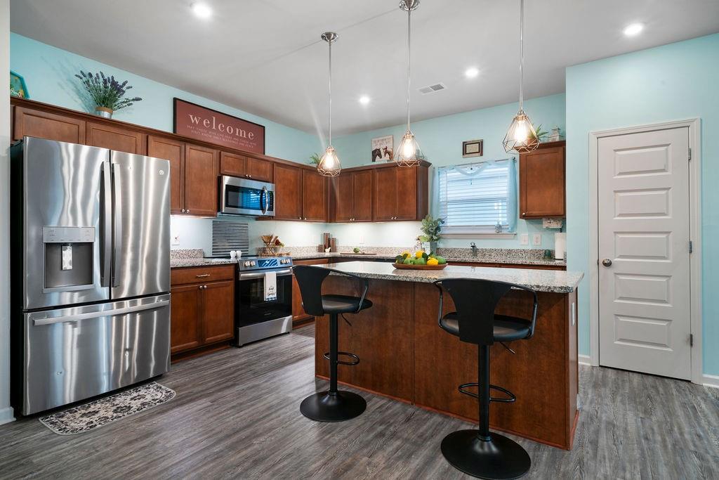 17 Brooke Court Southeast Rome, GA 30161 - Photo 13 of 32 a kitchen with granite countertop a refrigerator cabinets and wooden floor