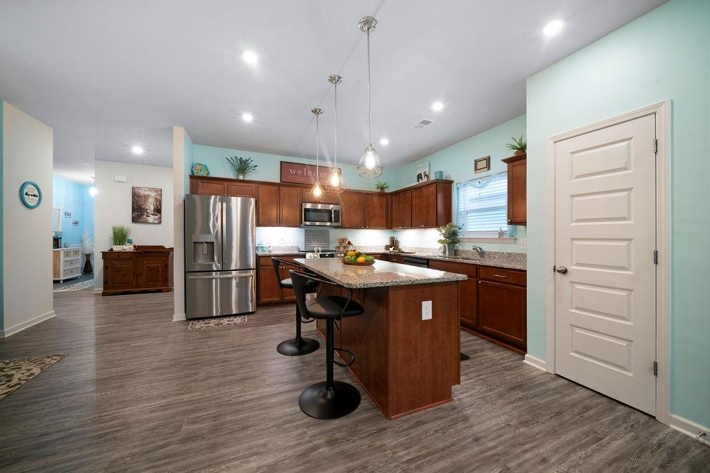 17 Brooke Court Southeast Rome, GA 30161 - Photo 14 of 32 a kitchen with stainless steel appliances kitchen island granite countertop a table chairs stove and refrigerator