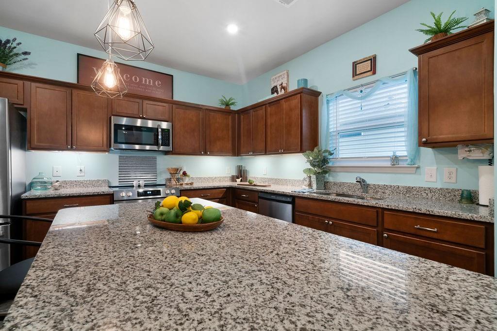 17 Brooke Court Southeast Rome, GA 30161 - Photo 17 of 32 a kitchen with stainless steel appliances granite countertop a sink a stove and a wooden cabinets