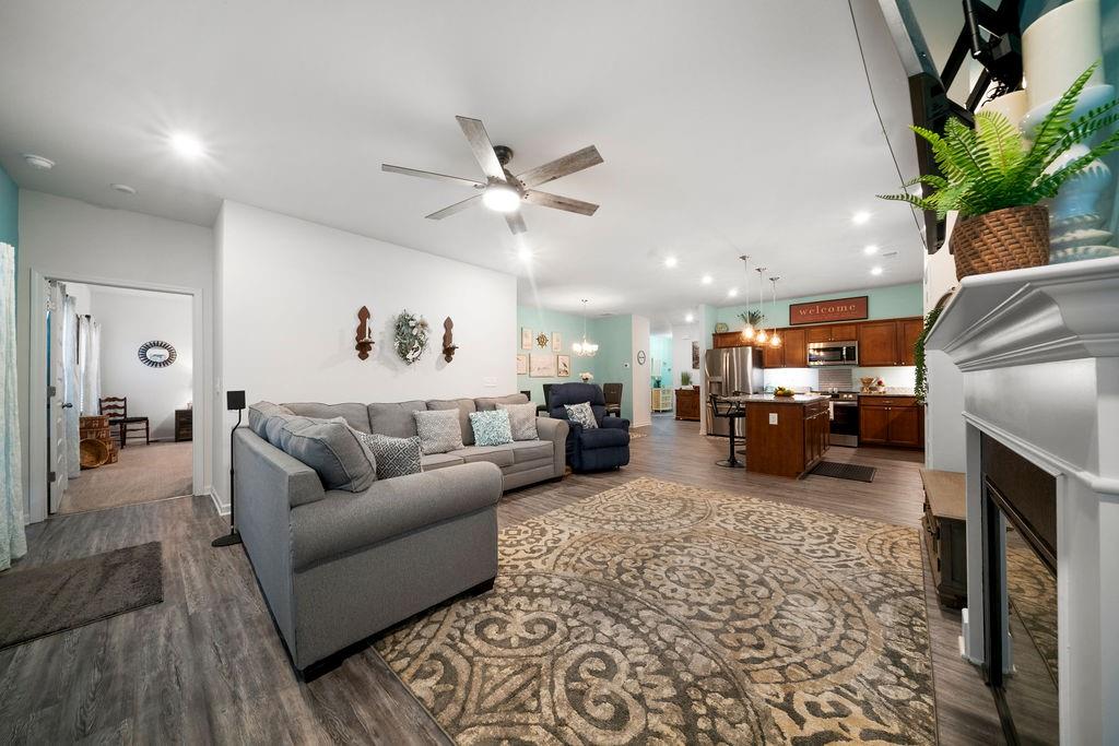 17 Brooke Court Southeast Rome, GA 30161 - Photo 20 of 32 a living room with furniture a fireplace and a chandelier