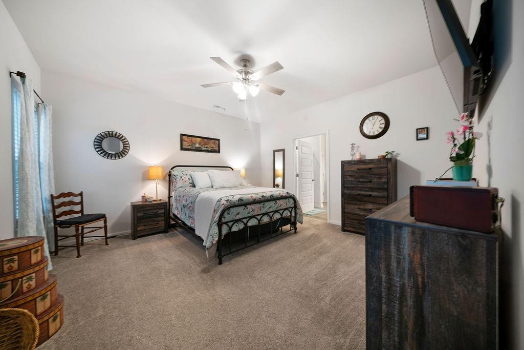 17 Brooke Court Southeast Rome, GA 30161 - Photo 22 of 32 a spacious bedroom with a bed and a chandelier