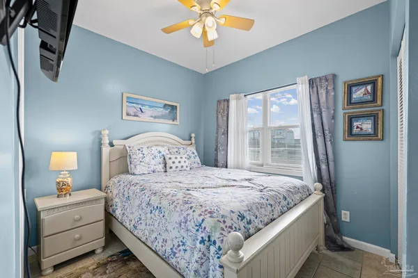 a bedroom with a bed and a flat tv screen in it