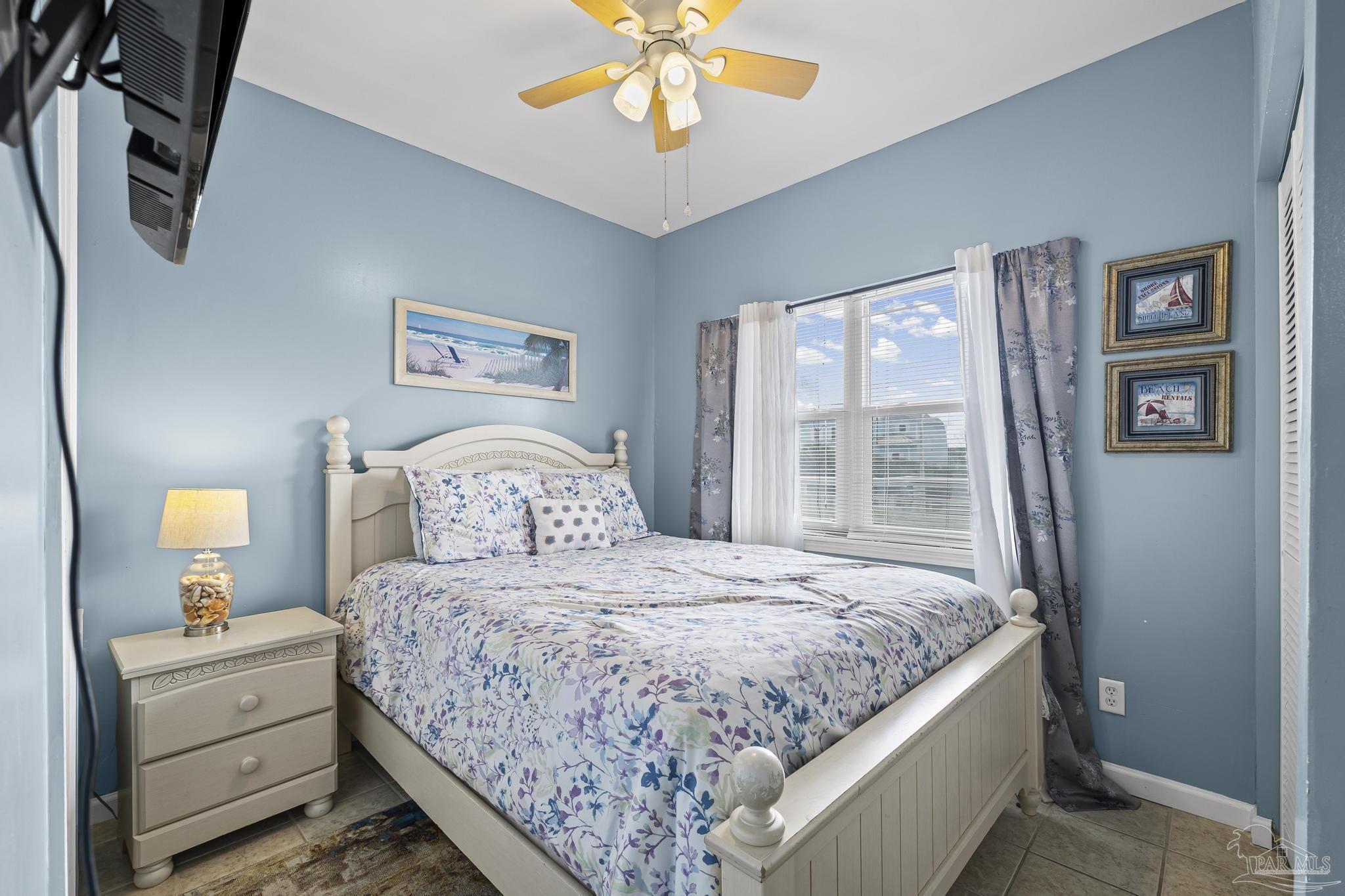 1150 Fort Pickens Road, Unit A1 Pensacola Beach, FL 32561 - Photo 12 of 45 a bedroom with a large bed and a chandelier