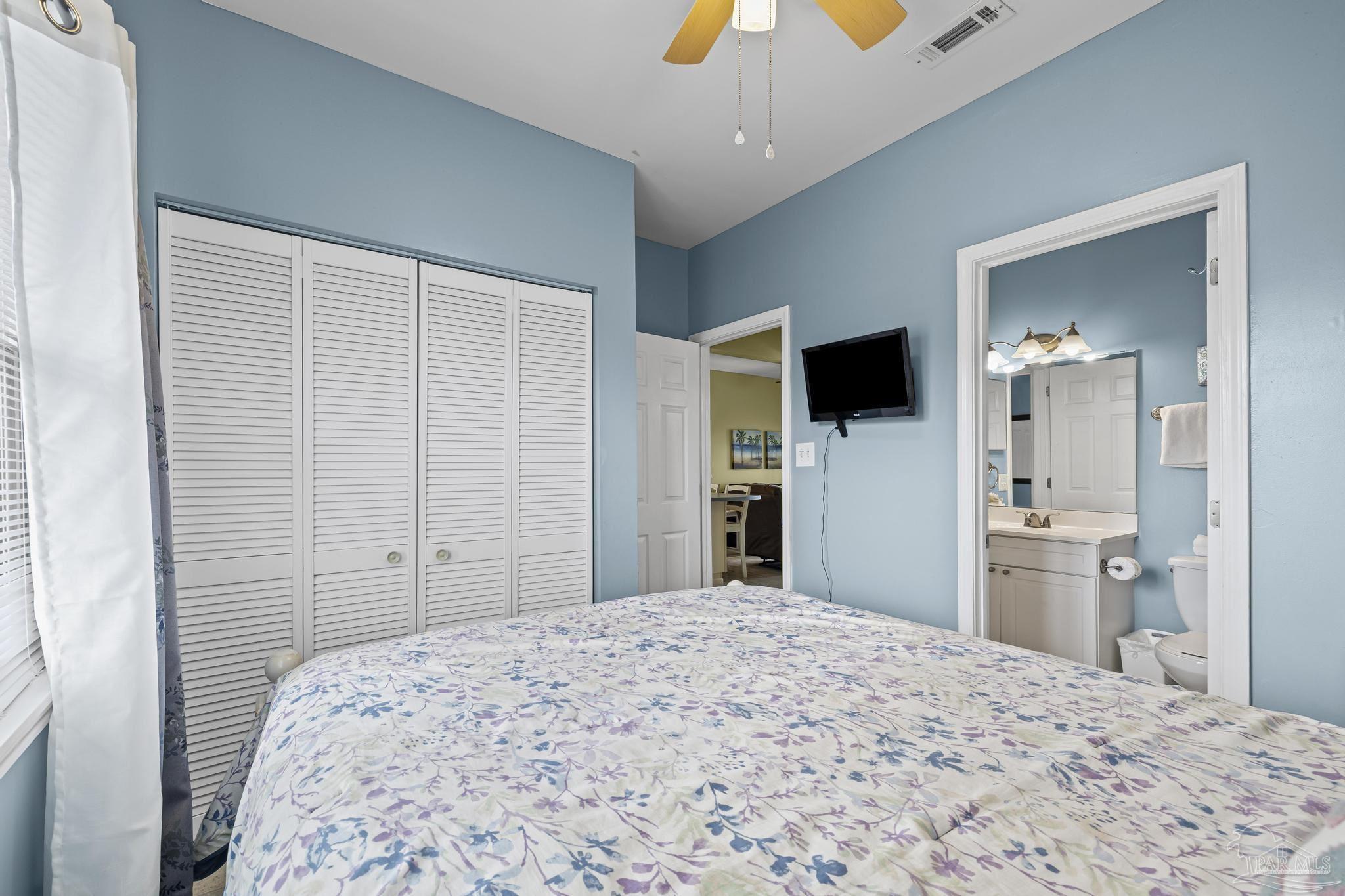 1150 Fort Pickens Road, Unit A1 Pensacola Beach, FL 32561 - Photo 13 of 45 a bedroom with a bed and a flat tv screen in it