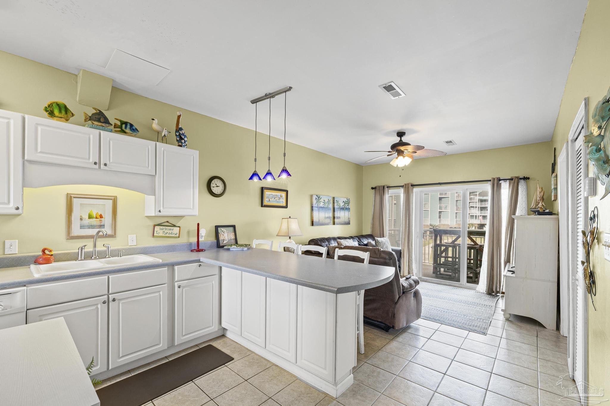 1150 Fort Pickens Road, Unit A1 Pensacola Beach, FL 32561 - Photo 15 of 45 a kitchen with a sink a stove and cabinets