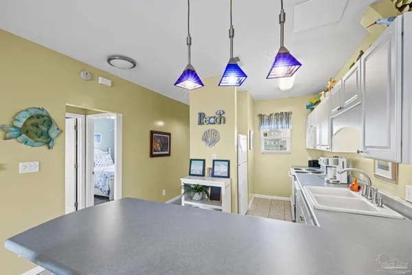 a kitchen with cabinets appliances a sink and a counter top space
