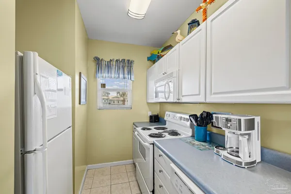 a kitchen with a sink a stove and cabinets