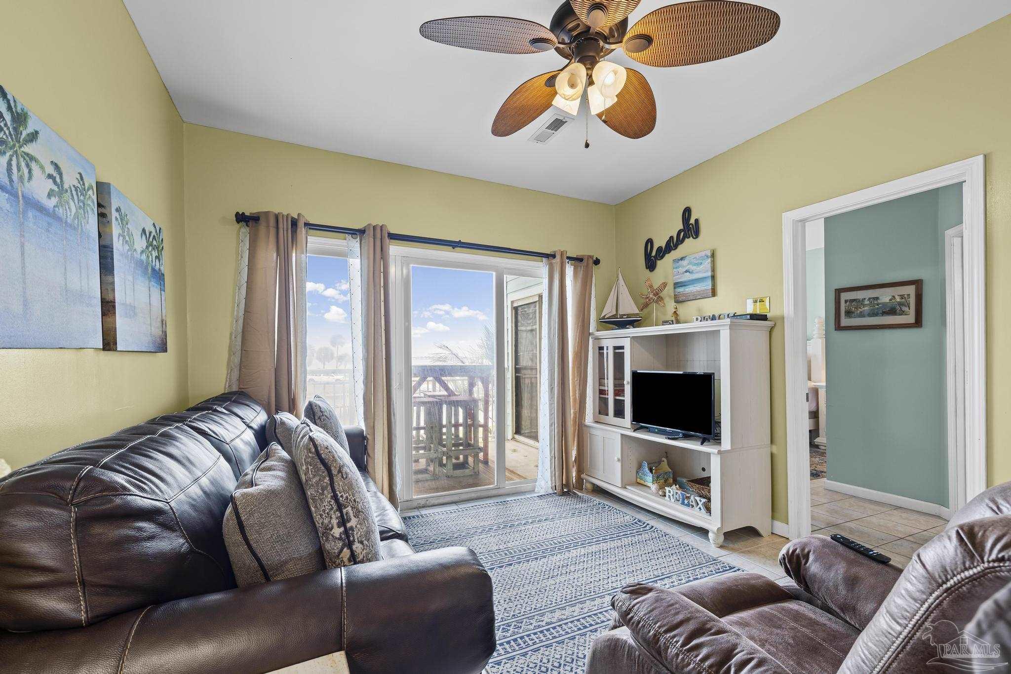 1150 Fort Pickens Road, Unit A1 Pensacola Beach, FL 32561 - Photo 24 of 45 a living room with furniture and a flat screen tv
