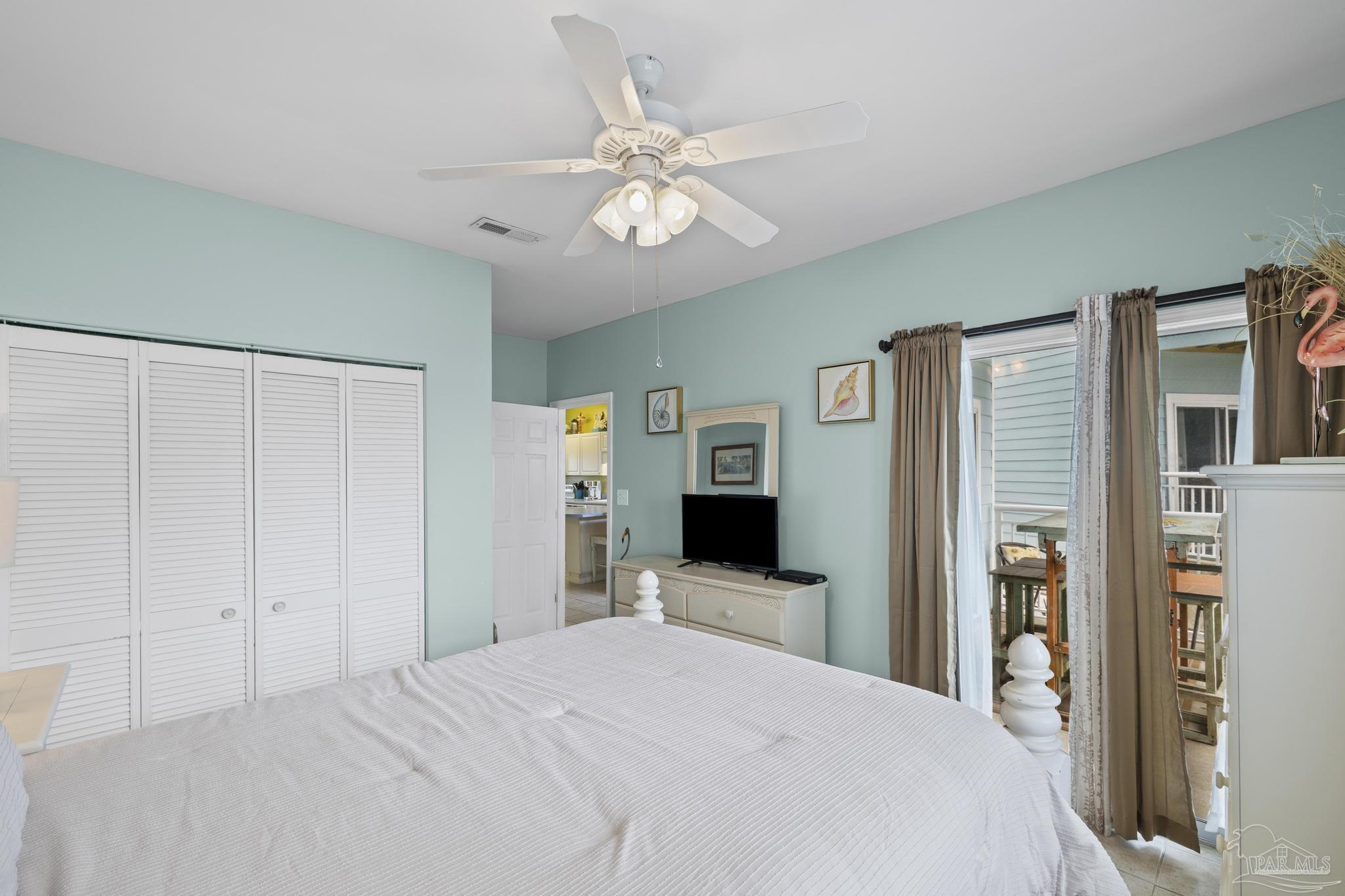 1150 Fort Pickens Road, Unit A1 Pensacola Beach, FL 32561 - Photo 27 of 45 a bedroom with a bed and a chandelier