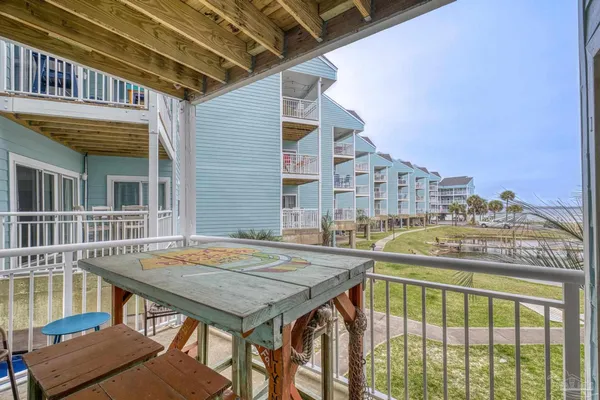 a balcony view with a table and chairs