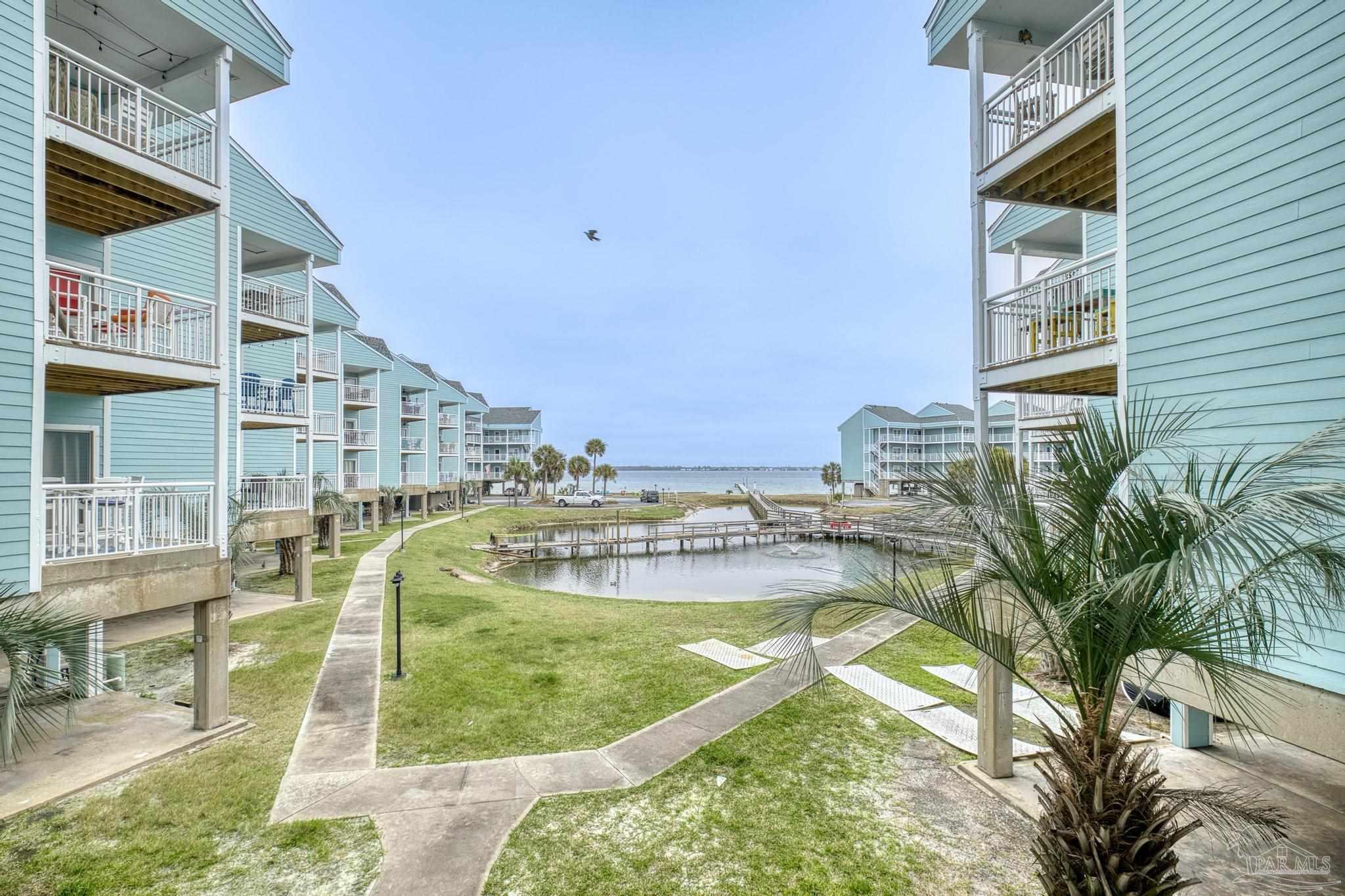 1150 Fort Pickens Road, Unit A1 Pensacola Beach, FL 32561 - Photo 32 of 45 a view of a swimming pool with a patio