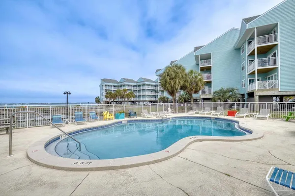 a view of a swimming pool with outdoor seating
