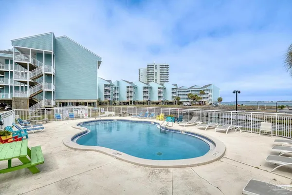 a view of a swimming pool with a lawn chairs