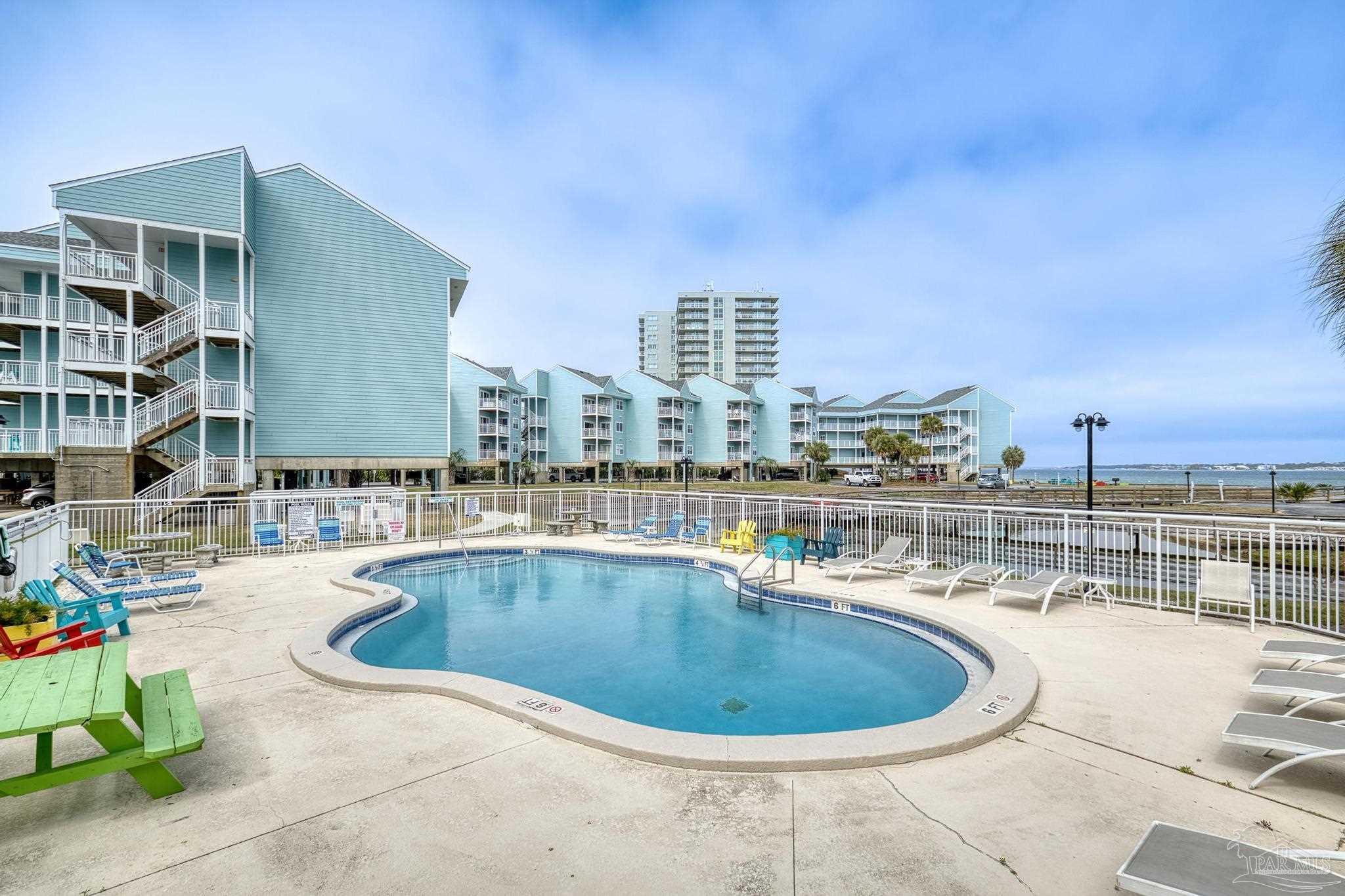 1150 Fort Pickens Road, Unit A1 Pensacola Beach, FL 32561 - Photo 37 of 45 a view of a swimming pool with outdoor seating
