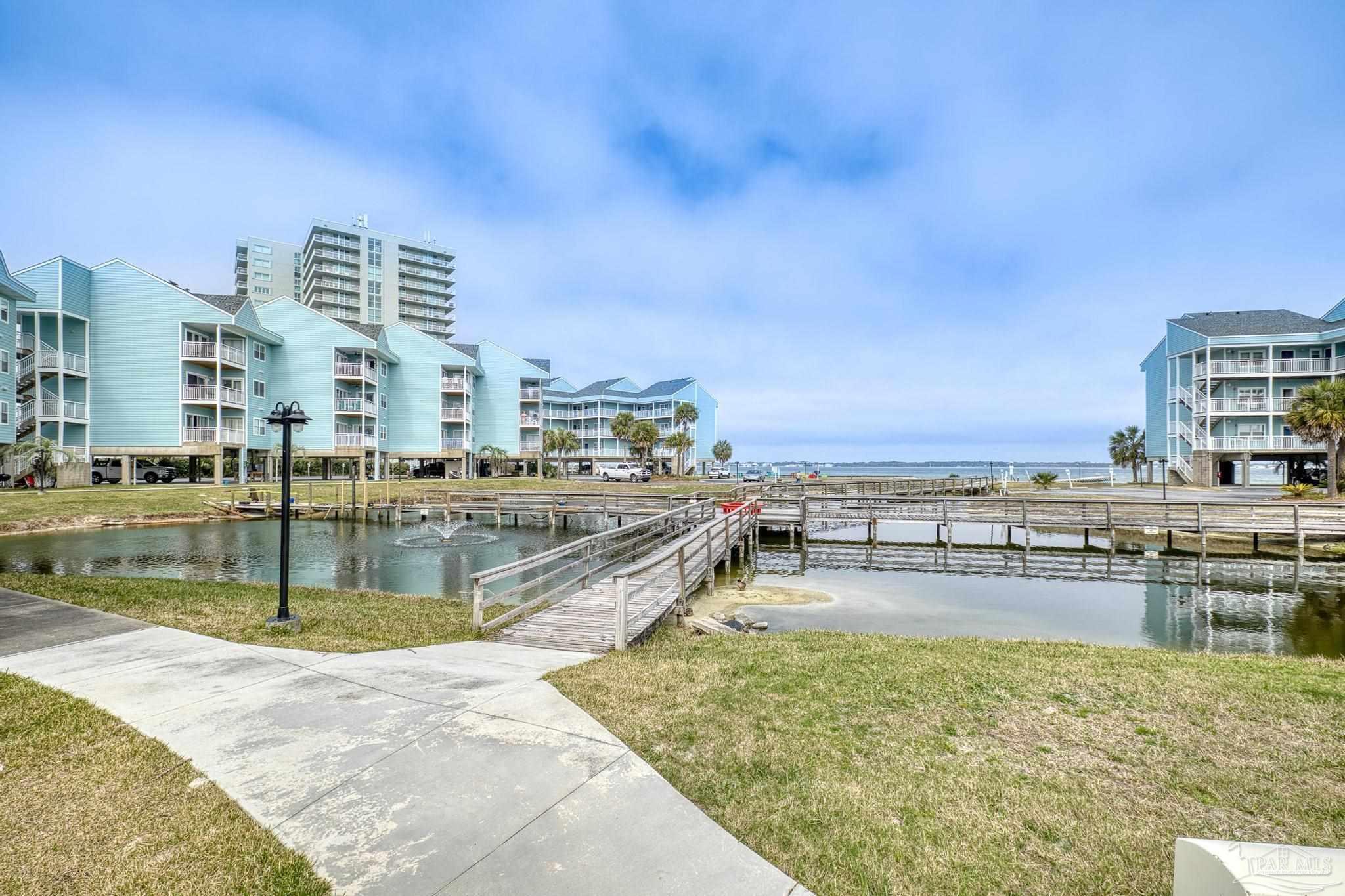 1150 Fort Pickens Road, Unit A1 Pensacola Beach, FL 32561 - Photo 38 of 45 a view of a swimming pool with a lawn chairs