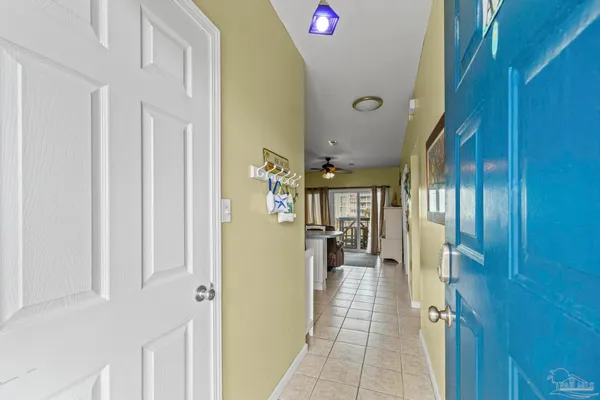 a hallway with a dining table and chairs