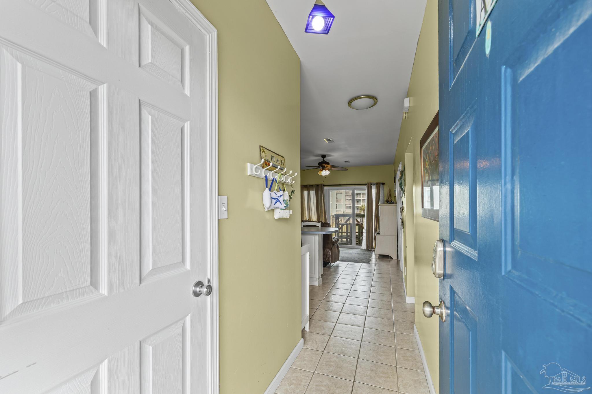 1150 Fort Pickens Road, Unit A1 Pensacola Beach, FL 32561 - Photo 7 of 45 a hallway with a dining table and chairs