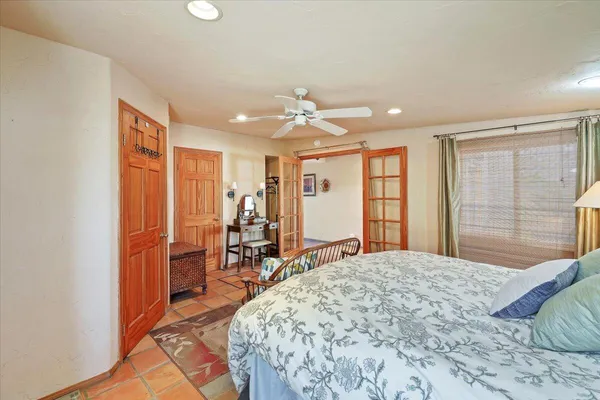 a bedroom with a large bed and large window