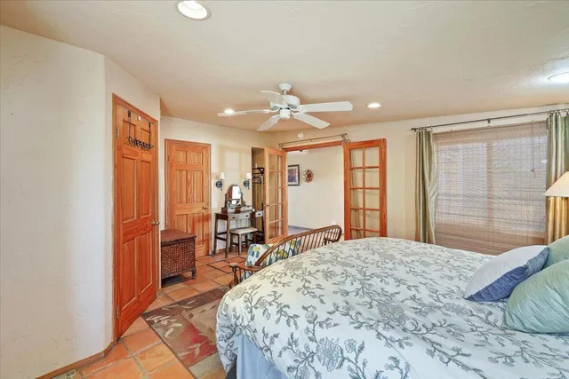 a bedroom with a large bed and large window