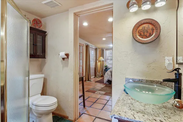 a bathroom with a toilet a sink and a mirror