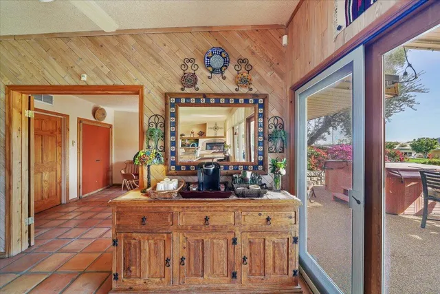 a view of a dining room with furniture a chandelier and wooden floor