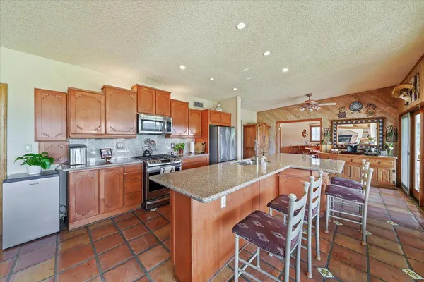 a large kitchen with a table and chairs in it
