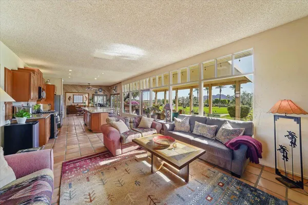 a living room with furniture fireplace and a large window