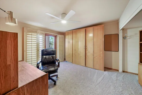 a view of a workspace with furniture and window