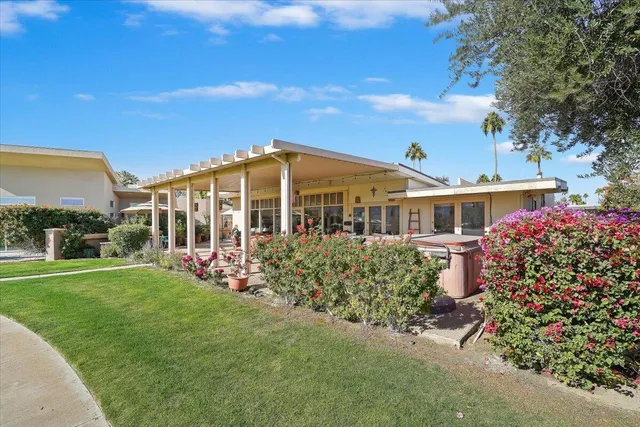 a view of a patio with table and chairs under an umbrella