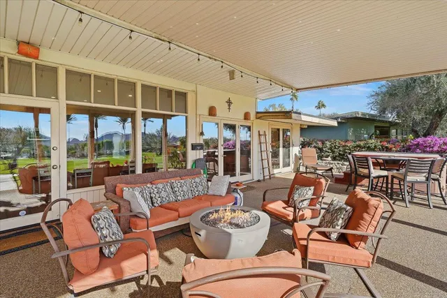 a view of a patio with table and chairs and potted plants