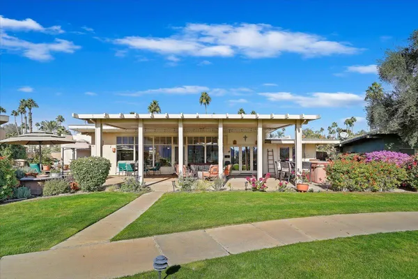a view of a garden with a building in the background