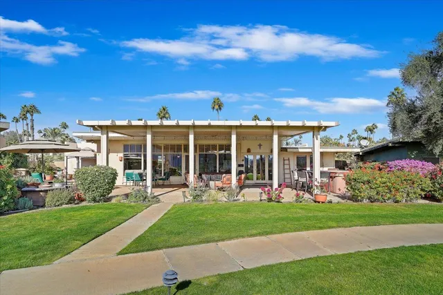 a view of a garden with a building in the background