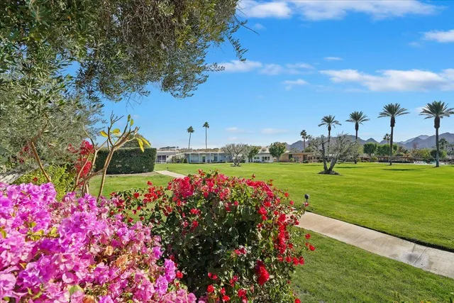 a view of a terrace with furniture and a lake view