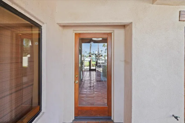 a view of a hallway view with wooden floor and a living room