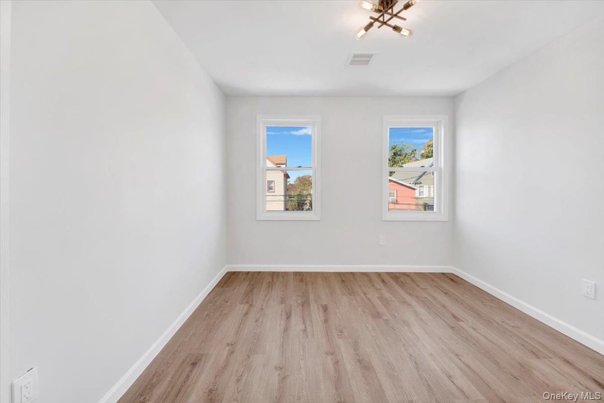 4626 Richardson Avenue, Unit 2 Bronx, NY 10470 - Photo 11 of 20 an empty room with a window and a ceiling fan