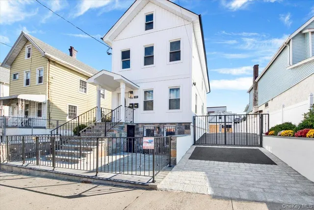 a view of a white building among the street