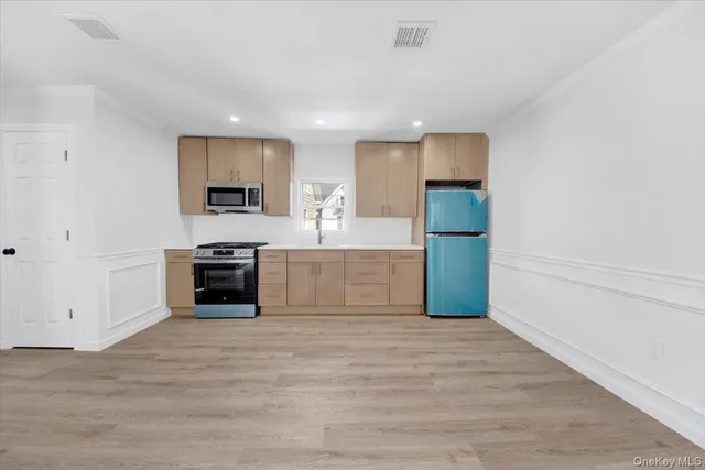 a large white kitchen with a stove top oven